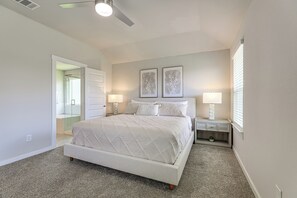 A bedroom with a bed, bedside lamps, a nightstand, a window with blinds, and a ceiling fan. - Work & Explore! Sleek Richmond Home w/ Pool Access (Richmond)