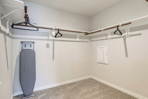 A laundry area with a drying rack, a hanging clothes rack, and a utility wall with a power outlet. - Work & Explore! Sleek Richmond Home w/ Pool Access (Richmond)