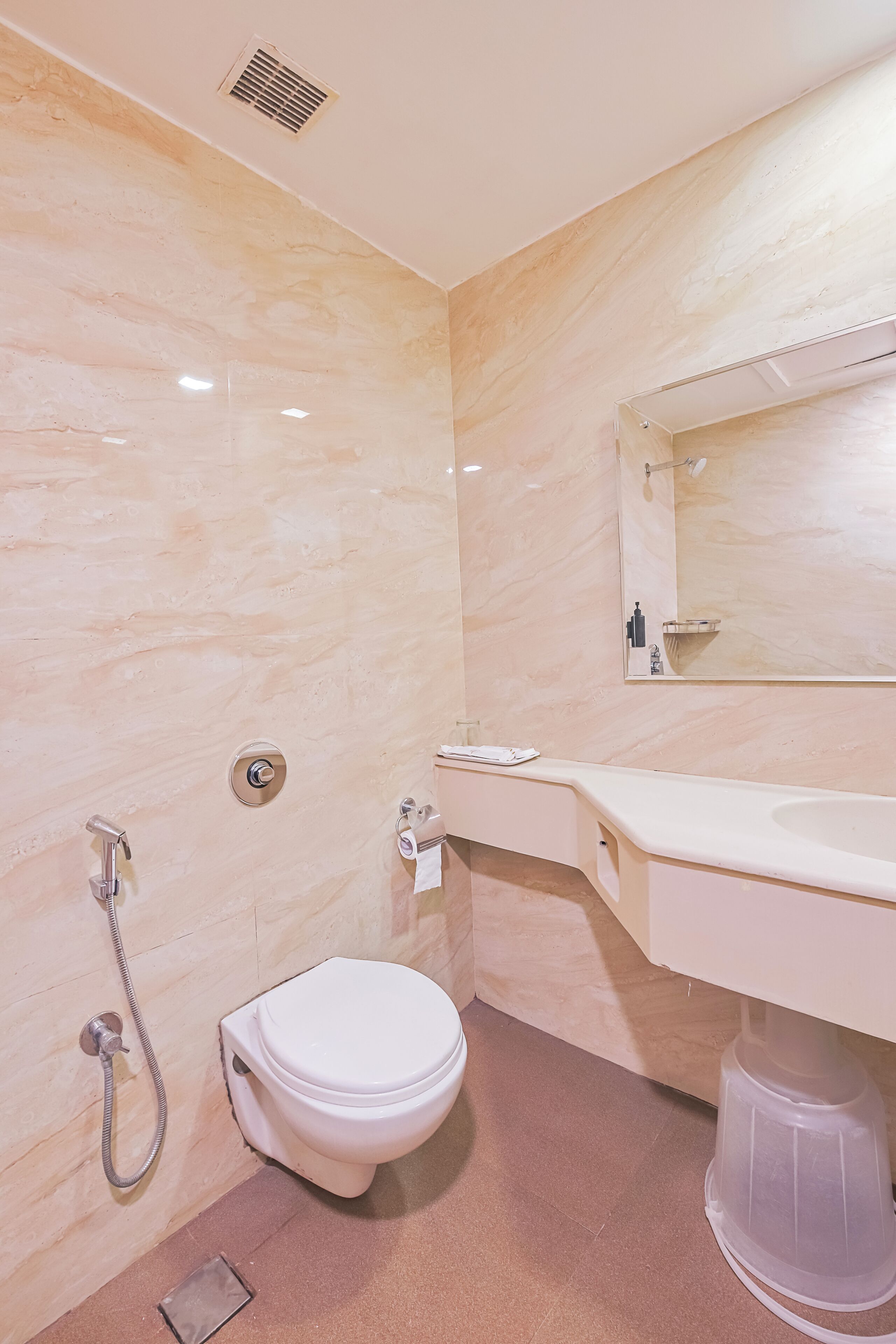 A bathroom with a toilet, sink, and shower.
