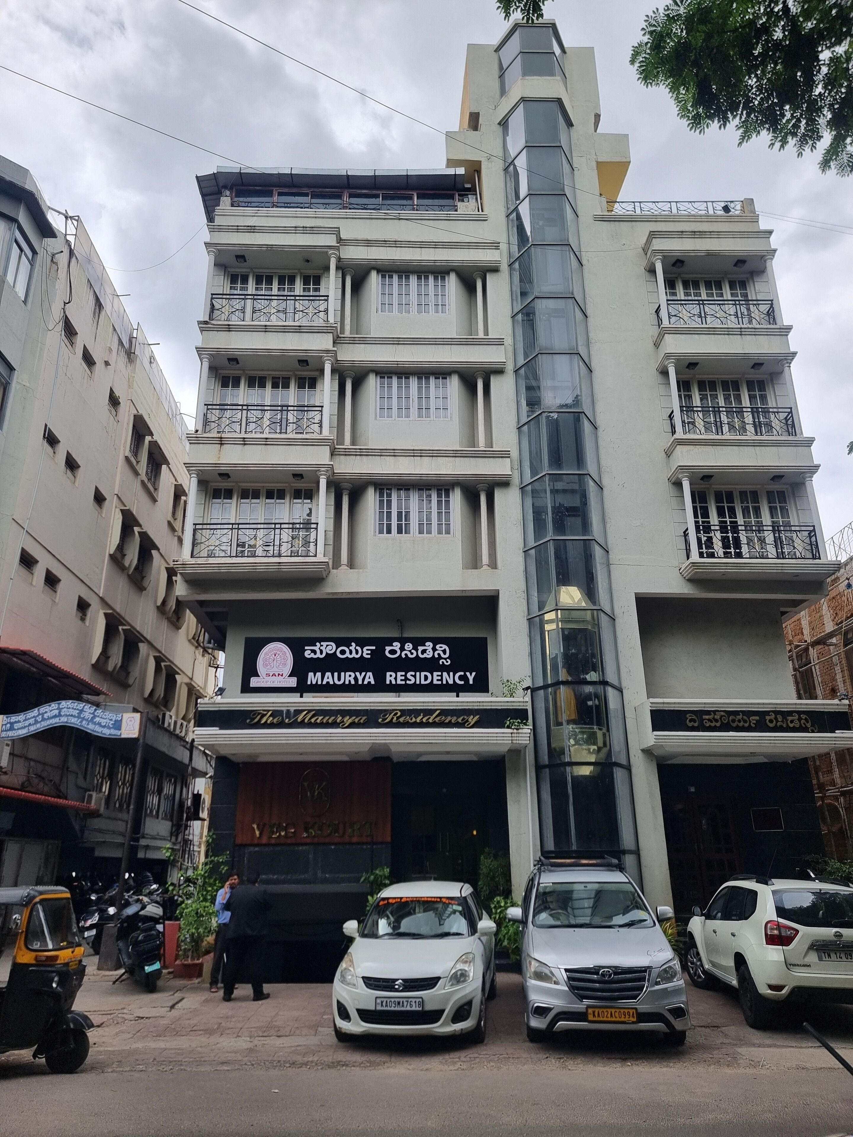 A multi-story building with a sign for Maurya Residency.