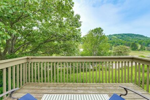 A wooden deck with a railing, overlooking a lush green landscape with trees and hills. - Greek Peak Retreat! Townhome w/ Mountain Views (Cortland)