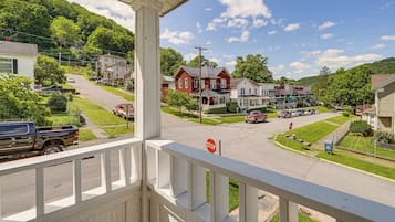 A residential street with houses, a stop sign, and a clear sky.