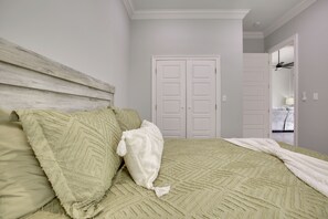 A bedroom with a bed, a white door, and a hallway leading to another room. - 4 Mi to New Orleans! Extended Stay in Arabi (Arabi)