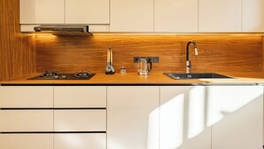A kitchen with a wooden countertop, a sink, a stove, and a coffee maker. - Elegant 2BR Private Pool Villa Umalas (Badung)