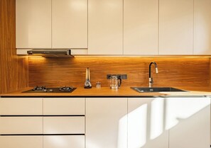 A kitchen with a wooden countertop, a sink, a stove, and a coffee maker. - Elegant 2BR Private Pool Villa Umalas (Badung)