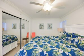 A bedroom with a bed, a chair, a ceiling fan, and a window with blinds. - Walk to Beach! Old Naples Condo w/ Pool Access (Naples)