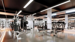 A modern gym with various exercise equipment, including weight machines and free weights. - Midori Hotel Da Lat (Lam Vien - Da Lat)