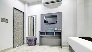 A bathroom with a toilet, sink, mirror, and a bed. - Super Collection O Mahakal (Ujjain)