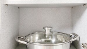 A kitchen with two stainless steel pots on shelves. - House Gangnam - offers a modern, cozy space (Seoul)