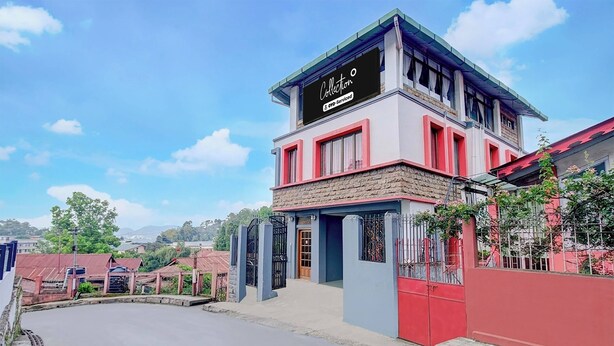 A two-story building with a sign that reads 'Collection' and 'Yoo-Served'.