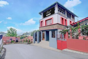 A two-story building with a sign that reads 'Collection' and 'Yoo-Served'.