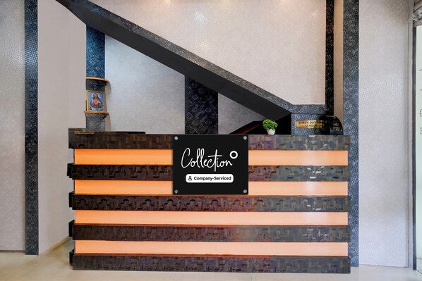 A reception desk with a sign indicating it is company-serviced.