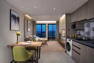Premier Studio Suite, City View | Living area | 60-inch Smart TV with digital channels