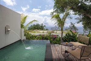 A pool with a water feature, surrounded by lush greenery and overlooking a scenic view. - The Sankara Hill Penida (Penida Island)
