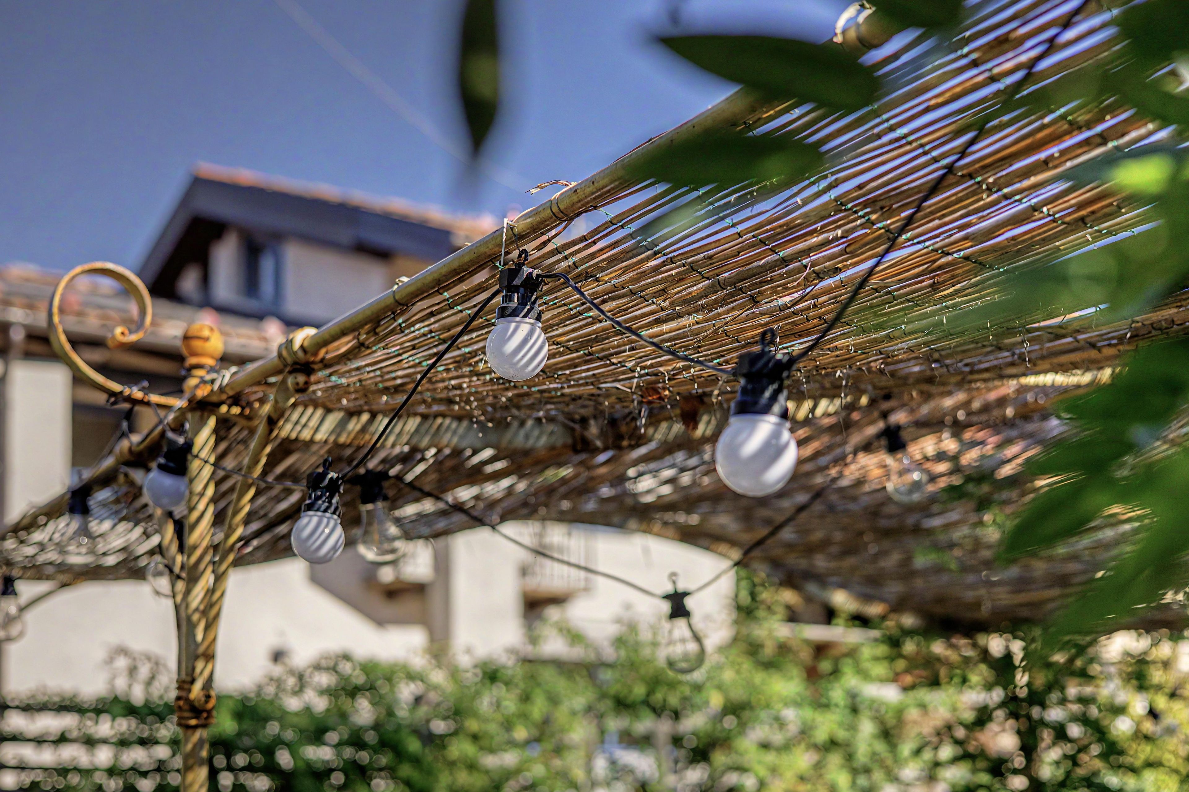 A hammock with multiple light bulbs attached to it.