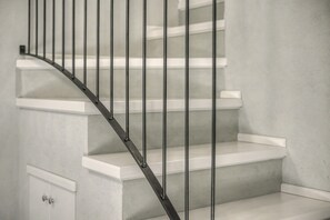 A staircase with metal railings and white steps.