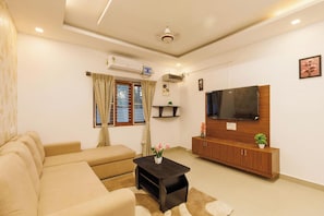 Apartment (1 Bedroom) | Living area | 60-inch Smart TV with digital channels - Aaravati Villa by Stayjade Pool 1hr E-city (Denkanikota)