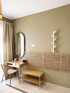 A room with a desk, chair, mirror, and a wall-mounted coat rack. - Nostos Home by Rentals Pro - Polychrono Halkidiki (Polychrono)