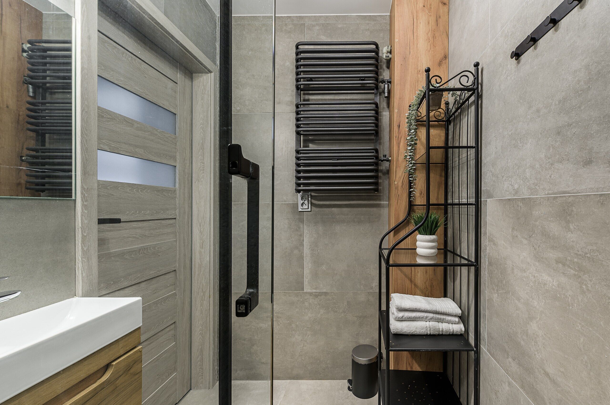 A modern bathroom with a shower, a toilet, and a sink.
