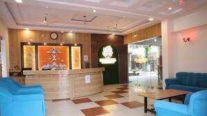 A hotel reception area with a check-in counter, a clock, and a logo for 'Shree Krishna Hotel & Restaurant'. - Shree Krishna Hotel & Restaurant (Sakrai)