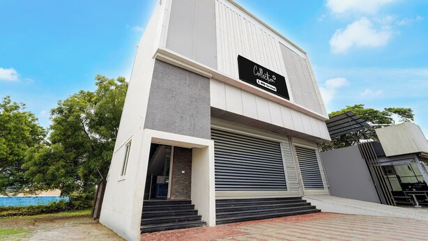A modern building with a large sign indicating a collection service. - Collection O Thiruparankundram City (Madurai)