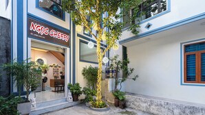 A building with a sign reading 'NGOC CHERRY' and a tree with lights in front. - Ngoc Cherry (Hoa Lu)