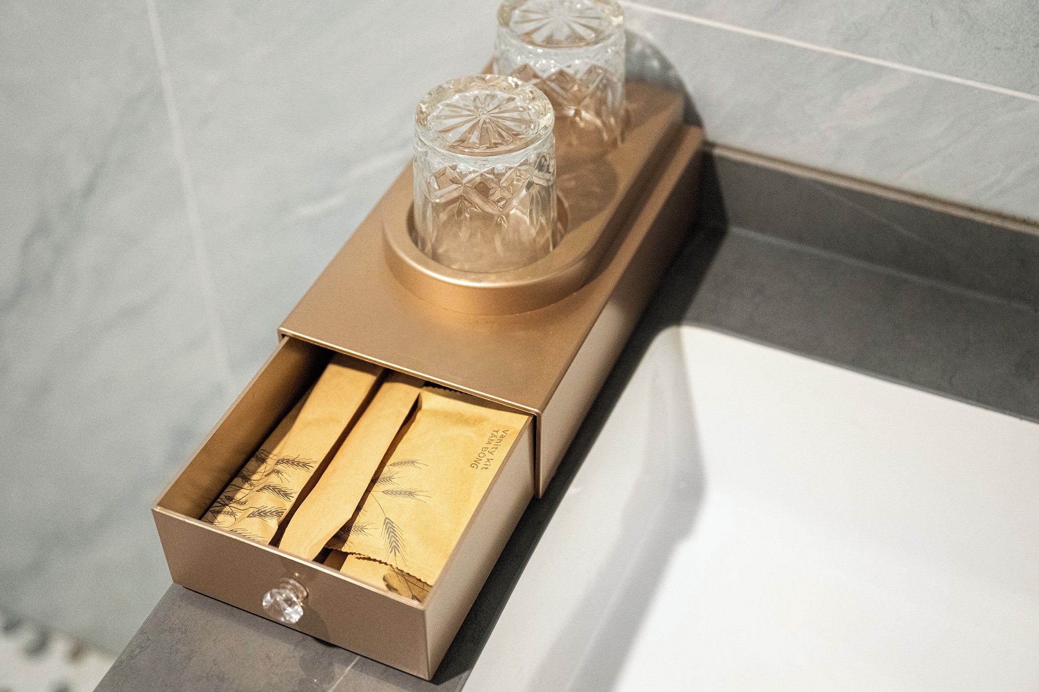 A box with two items, possibly candles, on a countertop.