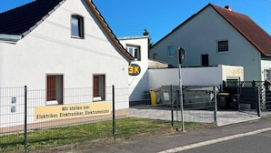 A building with a sign indicating it is a facility for electricians and electronics technicians.