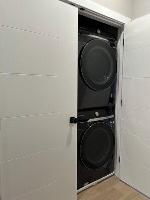A white wardrobe with a Samsung washing machine installed inside. - Modern South Philly Townhome. Rooftop. Skyline Views. Home Office.  Gym (Philadelphia)