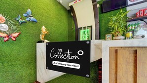 A reception desk with a sign that reads 'Collection Company-Serviced.' - Super Collection O Madurai Theni Road (Usilampatti)