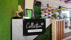 A reception desk with a sign that reads 'Collection Company-Serviced.' - Super Collection O Madurai Theni Road (Usilampatti)