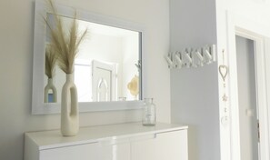 A bathroom vanity with a mirror, a vase with dried plants, and a glass jar. - Moments by the Sea - Trogir (Mastrinka)
