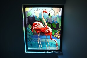A stained glass window with a flamingo.