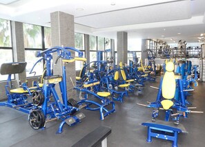 A gym with various exercise machines, large windows, and a modern interior design. - 4.97 Super Host`s New Boutique & Prime Location (Limassol)