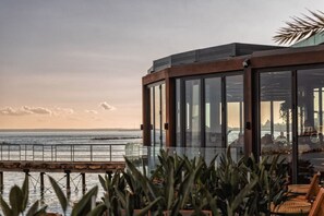 A modern building with large glass windows overlooking a body of water. - 4.97 Super Host`s New Boutique & Prime Location (Limassol)
