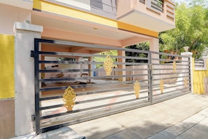 A gated entrance with a metal gate and decorative golden elements. - Super Collection O Madurai Junction (Madurai)