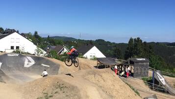 A mountain biking track with a ramp and a spectator area.