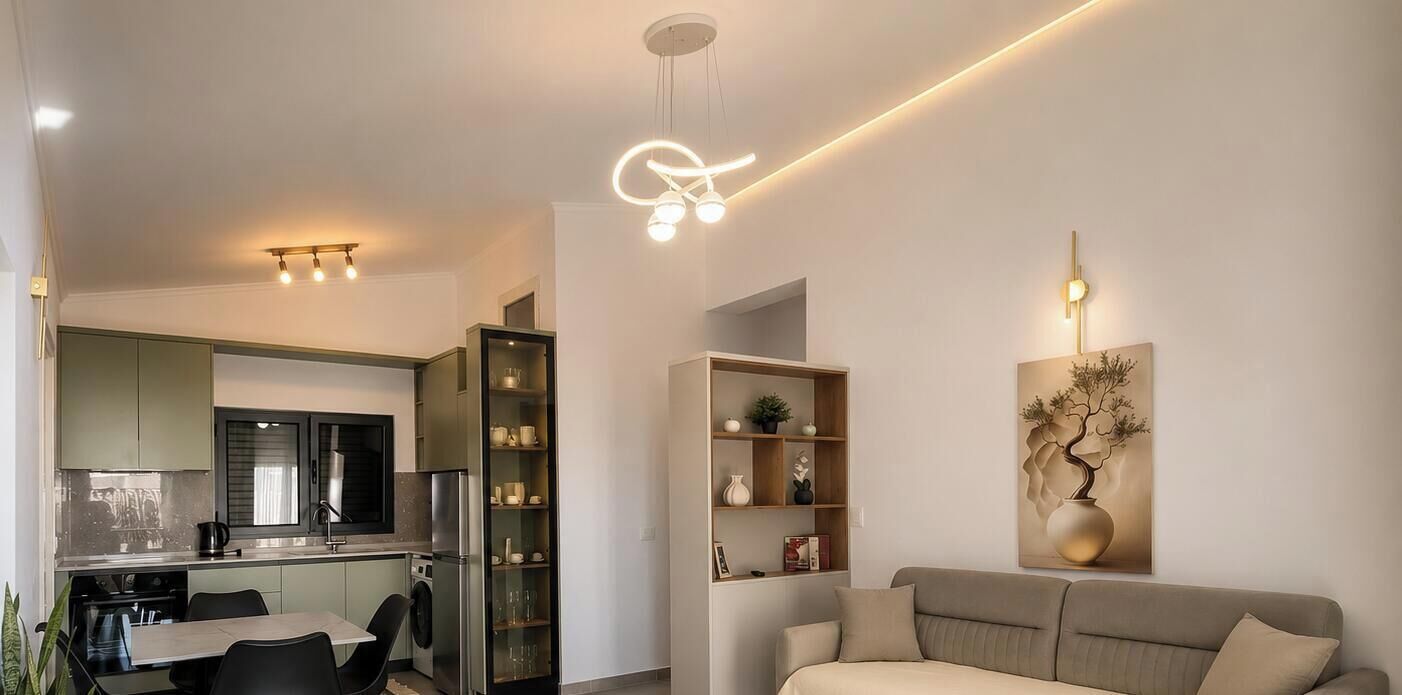 A modern kitchen with a dining area and a living room.