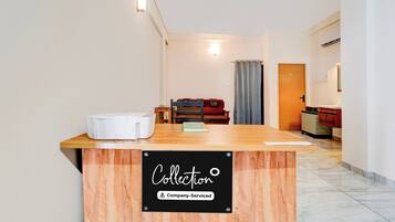 A reception desk with a sign indicating 'Collection Company-Serviced.'
