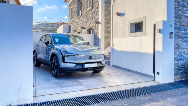 A modern building with a stone facade and a car parked in front. - Casa São Tiago, a Home in Madeira (Ponta do Sol)