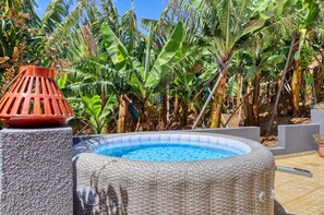 An outdoor swimming pool surrounded by lush banana trees. - Sunrise House, a Home in Madeira (Ponta do Sol)