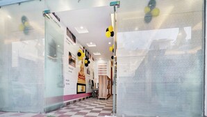 A hotel entrance with a checkered floor, glass doors, and a corridor leading inside. - Collection O Rajeev Nagar Near Atal Path (Patna)