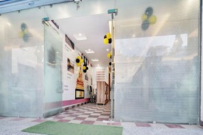 A hotel entrance with a checkered floor, glass doors, and a corridor leading inside. - Collection O Rajeev Nagar Near Atal Path (Patna)