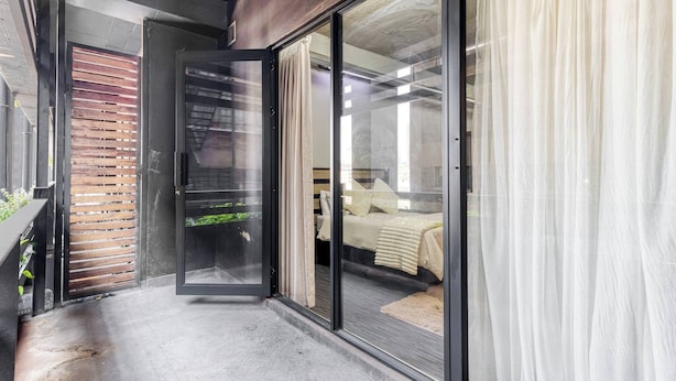 A modern interior with a sliding glass door leading to a bedroom.