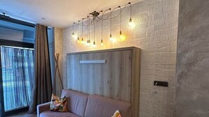 A modern living room with a sofa, a coffee table, and a side table. - Magnificent brand-new home next to Plaza España (Valencia)