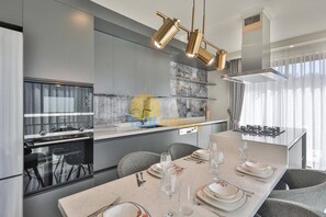 A modern kitchen with a central island, stainless steel appliances, and pendant lighting. - Luxury Villa Petra w Ndoor Heated Pool, Sauna (Kaş)