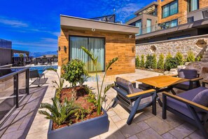 A modern outdoor patio with a pool, seating, and plants. - Luxury Villa Petra w Ndoor Heated Pool, Sauna (Kaş)