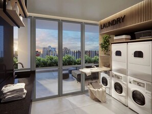 A modern laundry room with a city view, a sink, and a table with a plant. - Studio Completo - Aclimação (São Paulo)