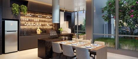 A modern kitchen with a built-in island, a refrigerator, and a dining area with chairs and a table set for two.