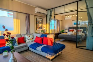 A modern hotel room with a sofa, a bed, a desk, and a large window. - 4.97 Super Host`s New Boutique & Prime Location (Limassol)